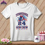 A white t-shirt hanging on a wooden background features a design reading "Tennessee 24 Sew Crew" with a spool of thread and needle.