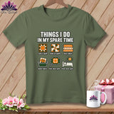 An olive green t-shirt with white text and illustrations about quilting displayed on a wooden background.