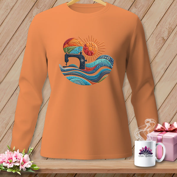 Orange long-sleeve shirt with a colorful sewing machine and sun graphic.