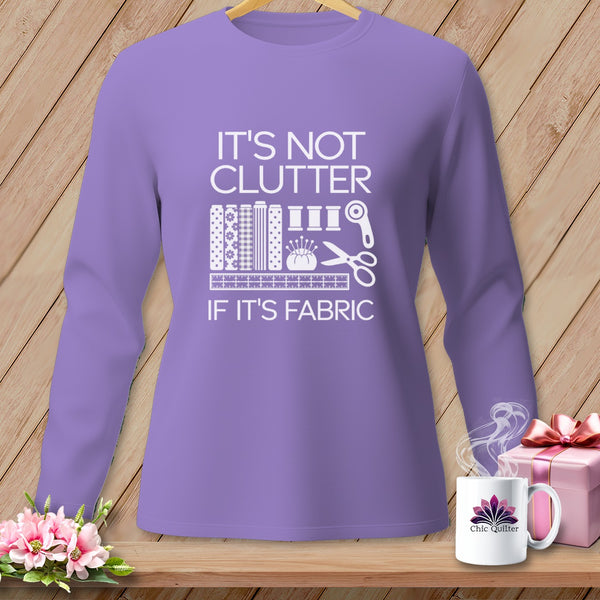 Purple long-sleeve shirt with "It's Not Clutter If It's Fabric" text.