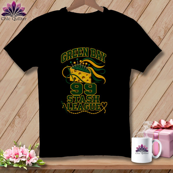 Black t-shirt featuring Green Bay 99 Stash League graphic with cheese wedge and sewing needles.