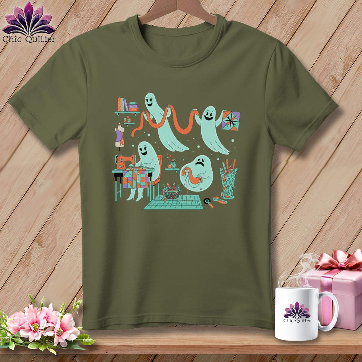 Ghosts sewing and quilting on a khaki t-shirt with a wooden background.