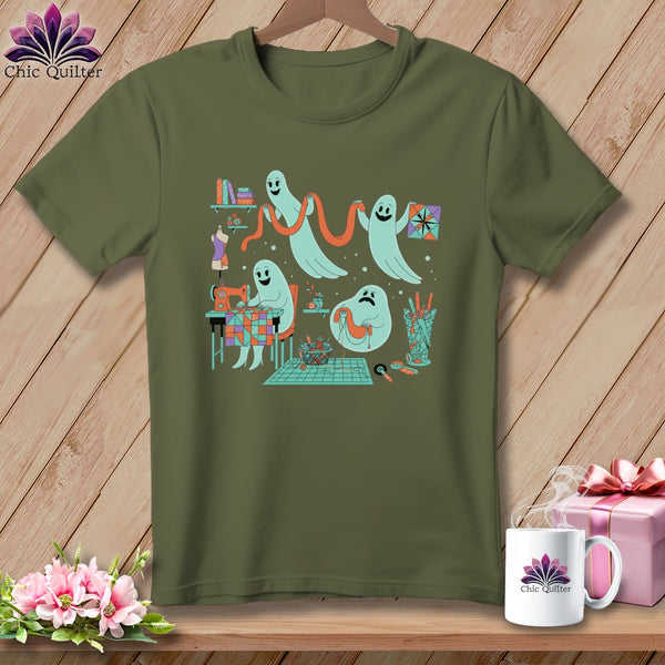 Ghosts sewing and quilting on a khaki t-shirt with a wooden background.