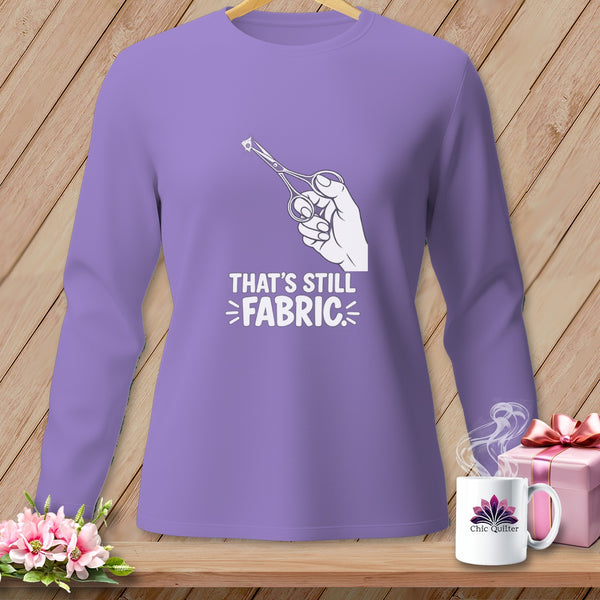 Purple long-sleeved shirt with "That's Still Fabric" graphic and scissors cutting fabric.