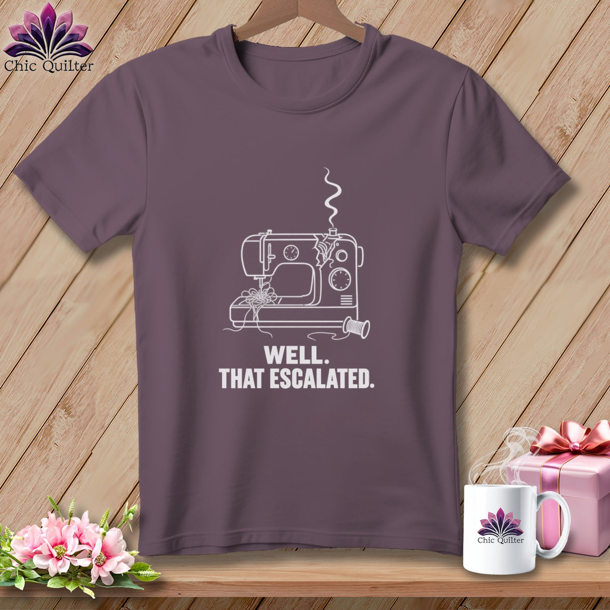 Purple t-shirt with a white line drawing of a sewing machine and text.