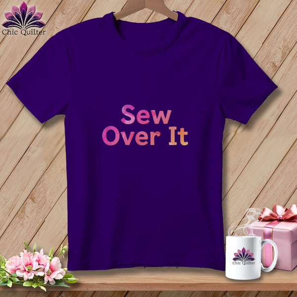 Purple t-shirt with pink and orange "Sew Over It" text, logo, gift, and flowers.