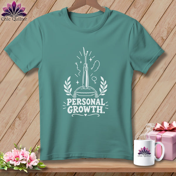 Teal t-shirt with white "Personal Growth" text and sewing illustrations.