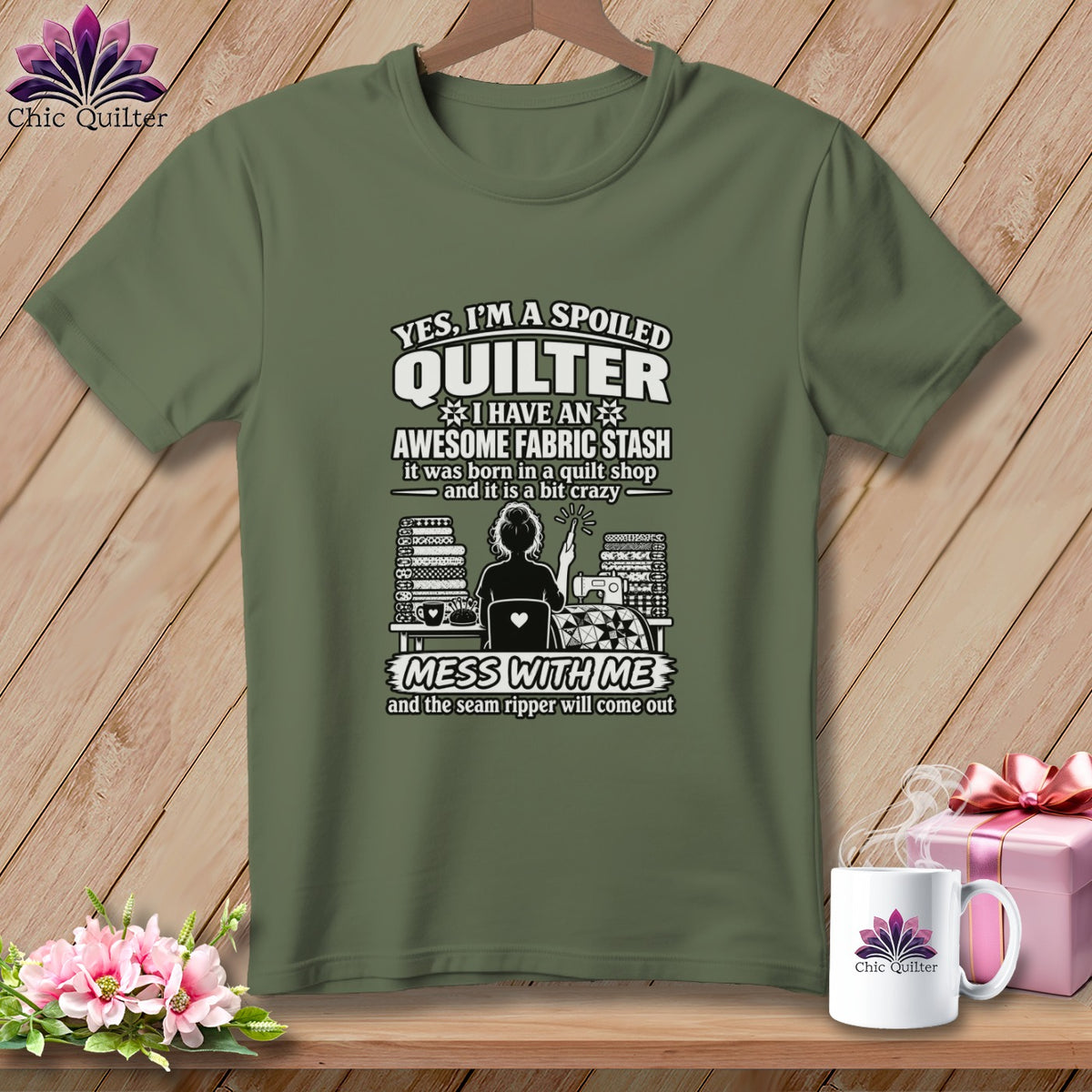An olive green t-shirt with white text reading "Yes, I'm a spoiled quilter, I have an awesome fabric stash."