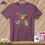 A purple t-shirt featuring a colorful patchwork design of three stylized birds on a wooden background.