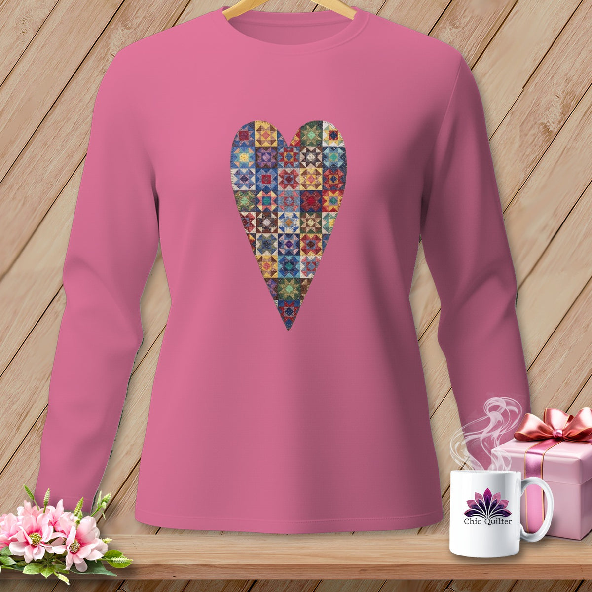 Pink long-sleeve shirt with a colorful patchwork heart graphic.
