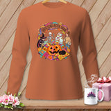 Halloween-themed graphic with witches, skeletons, and mummies on a long-sleeved orange shirt.