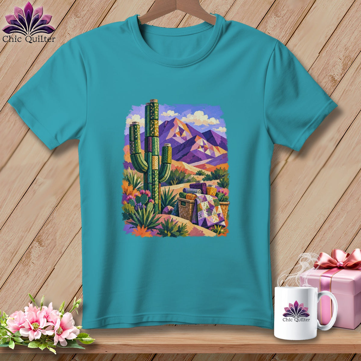 Teal t-shirt featuring a colorful painted desert scene with a saguaro cactus and mountains.