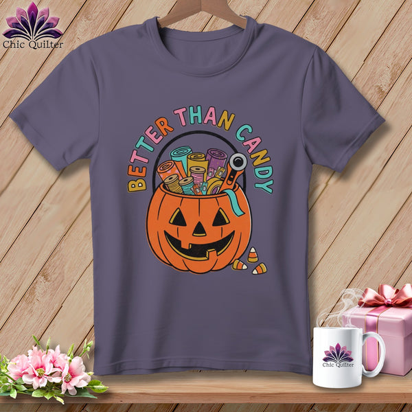 Purple t-shirt with pumpkin-shaped candy bucket filled with sewing supplies and "Better Than Candy" text.