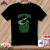 A black t-shirt hanging on a wooden background, featuring green text reading 