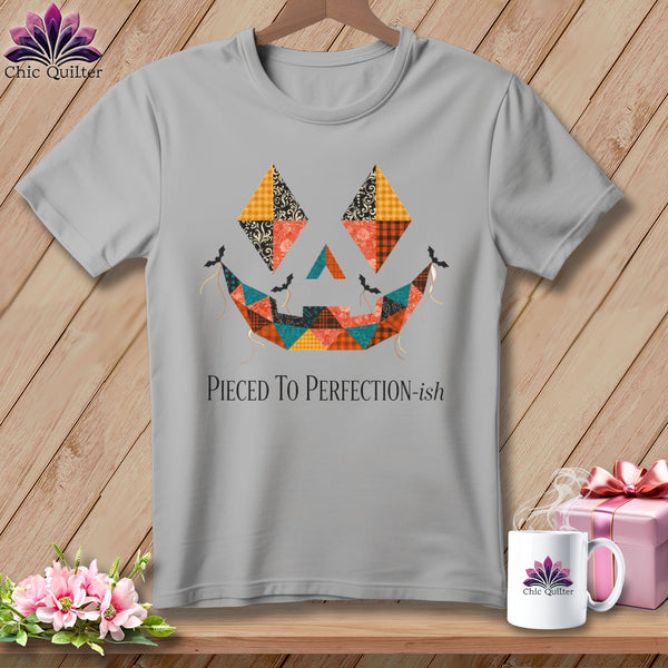 Gray t-shirt with a patchwork jack-o'-lantern face and "Pieced To Perfection-ish" text.
