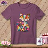 Purple crewneck t-shirt featuring a colorful patchwork fox graphic, displayed on a wooden surface.