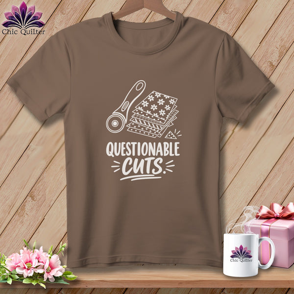 Brown t-shirt with white graphic of rotary cutter, fabric, and "Questionable Cuts" text.