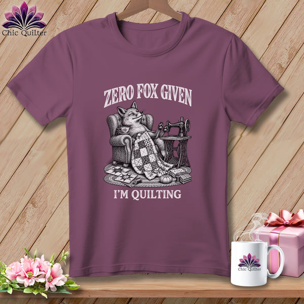 T-shirt with a fox lounging with a quilt, sewing machine, and text "Zero Fox Given I'm Quilting".