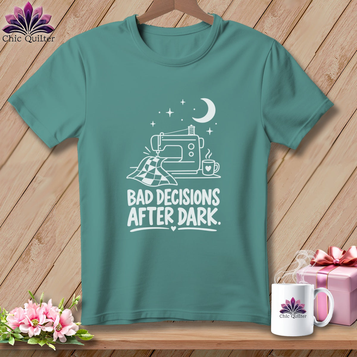 Teal t-shirt with white graphic of sewing machine, quilt, and text "Bad Decisions After Dark."