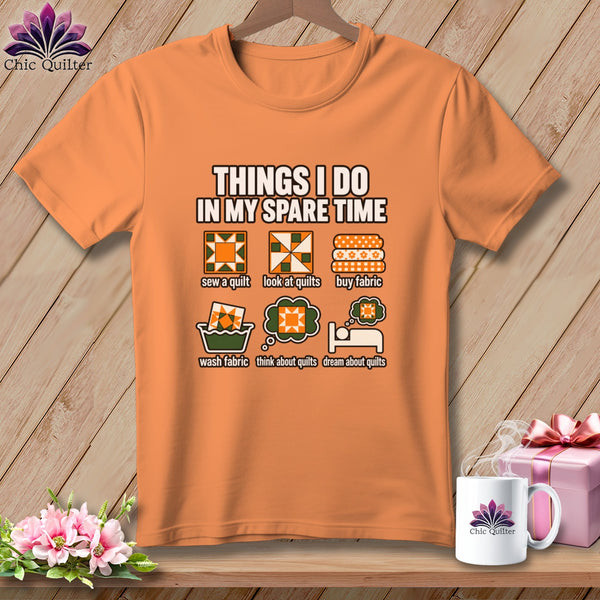 Orange t-shirt featuring quilting-themed illustrations and text about spare-time activities, displayed against a wooden background.