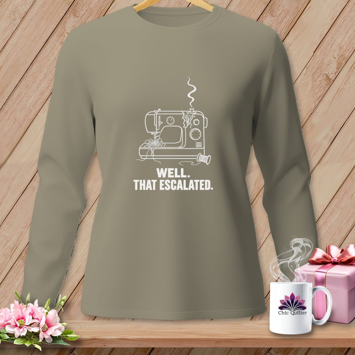 Long-sleeve shirt with a broken sewing machine graphic and text "WELL. THAT ESCALATED."