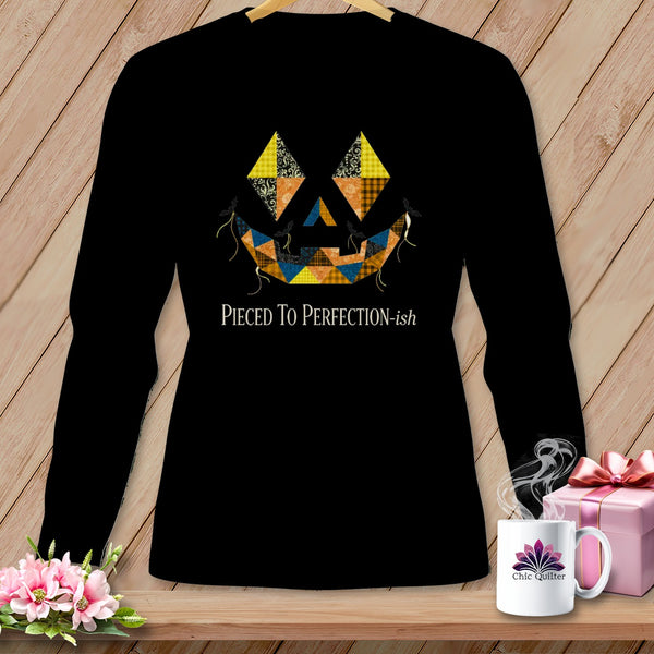Black long-sleeve shirt with patchwork jack-o'-lantern face and text "Pieced To Perfection-ish".