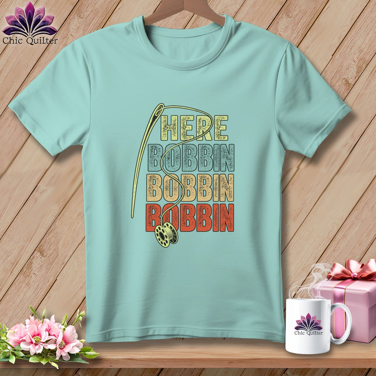 Light blue t-shirt with "HERE BOBBIN BOBBIN BOBBIN" text and sewing needle graphic.