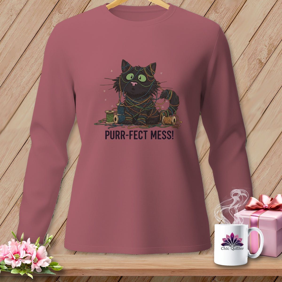 Black cat tangled in colorful yarn with "Purr-fect Mess!" text.