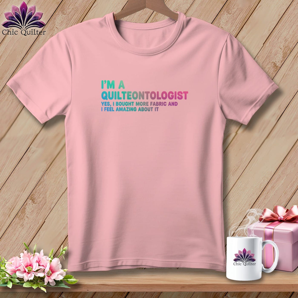 Pink t-shirt with "I'm a Quilteontologist" text, fabric, and gift.