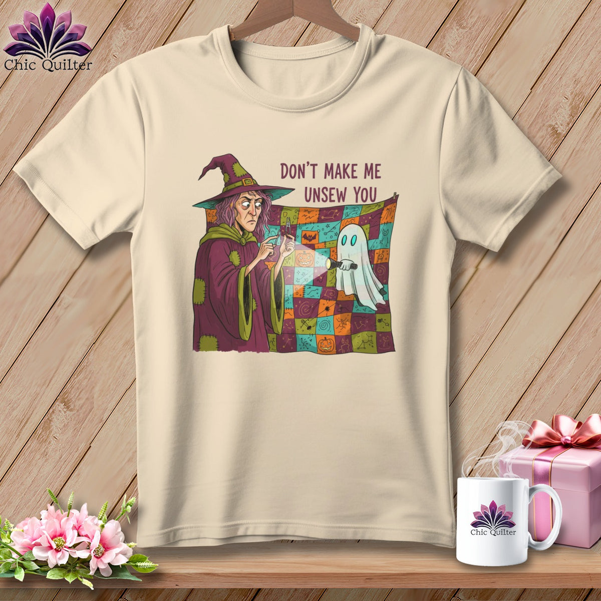Witch with flashlight shines on a ghost in front of a Halloween quilt that reads "Don't Make Me Unsew You."