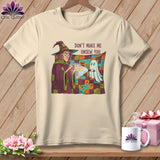 Witch with flashlight shines on a ghost in front of a Halloween quilt that reads 