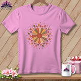 Pink t-shirt with a circular quilt design featuring spools of thread and buttons.