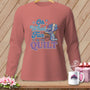 Long-sleeve shirt with "Oh What Fun It Is To Quilt" text and a sleigh filled with fabric rolls.
