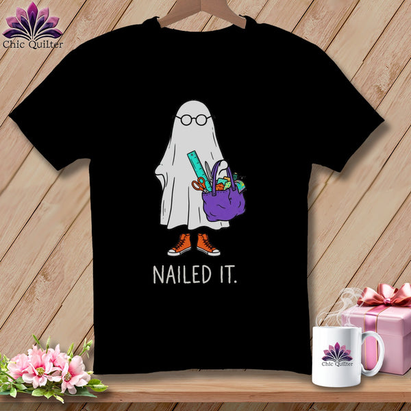 Black t-shirt with a ghost in glasses holding crafting supplies and the text "NAILED IT."