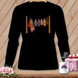Black t-shirt with colorful patchwork bats hanging on a clothesline.