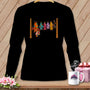Black t-shirt with colorful patchwork bats hanging on a clothesline.