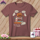 Halloween t-shirt with a pumpkin, ghosts, sewing machine, and text.