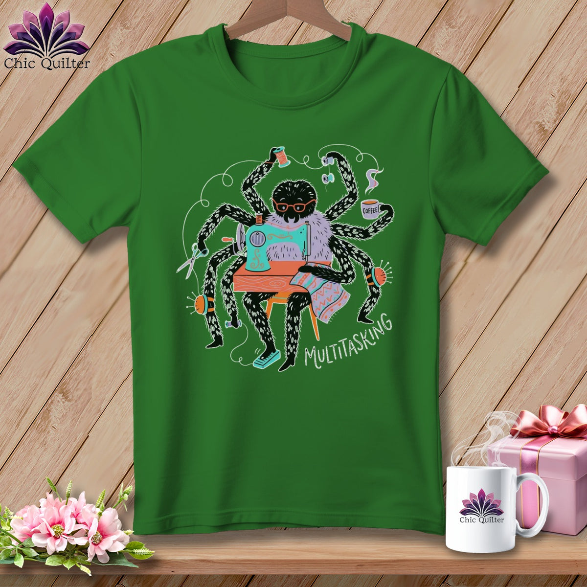 Green t-shirt with a spider sewing and holding coffee, text reads "MULTITASKING".