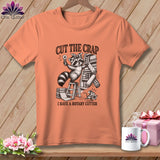 T-shirt with raccoon holding rotary cutter, text 