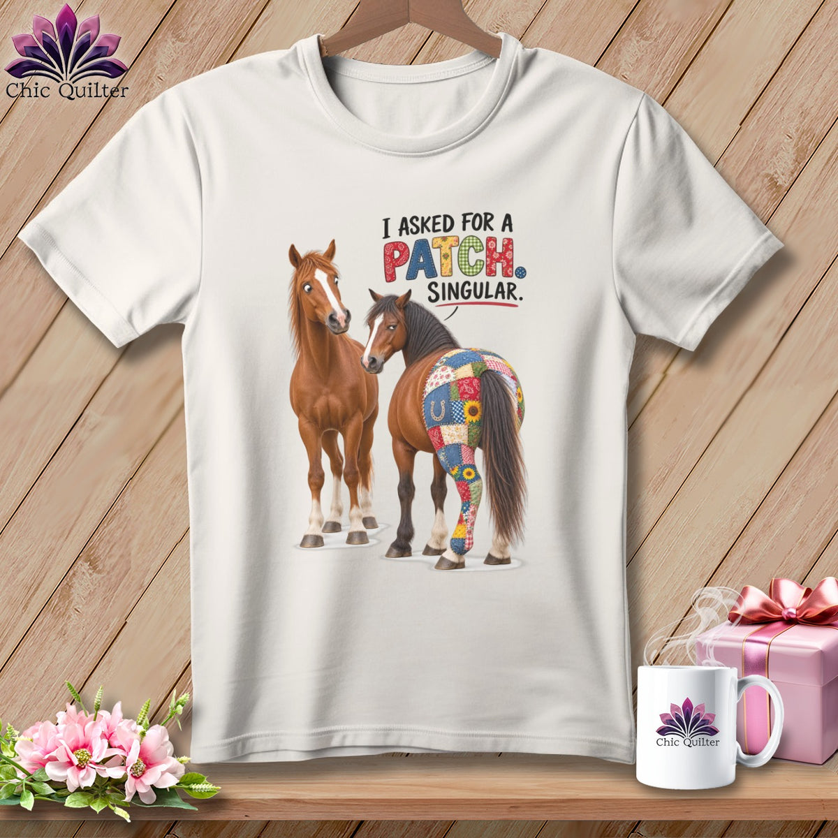 White t-shirt with two horses and the text "I ASKED FOR A PATCH. SINGULAR."