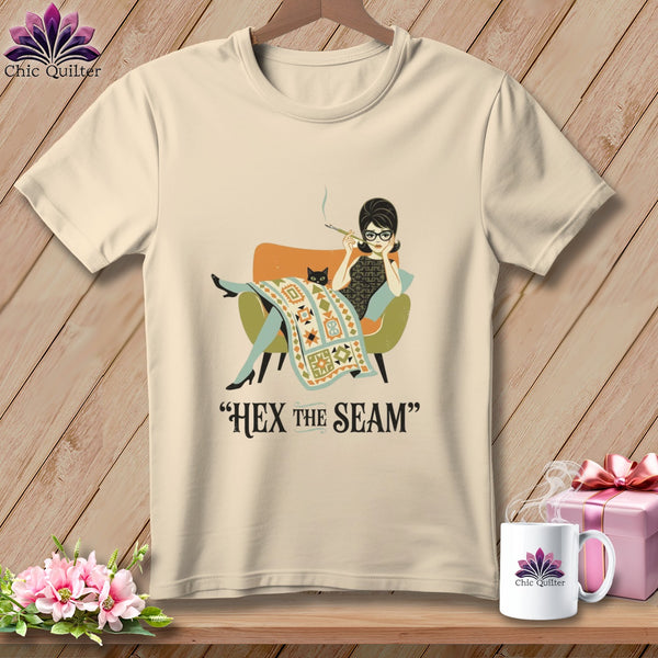 Cream t-shirt with illustration of woman smoking, black cat, and quilt with text "HEX THE SEAM".