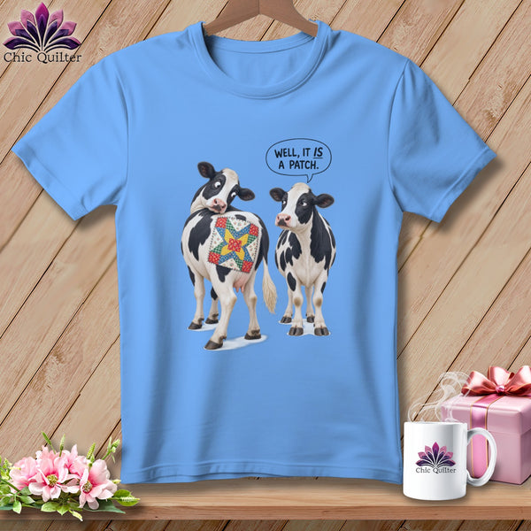 Two cows, one with a quilt patch, and speech bubble saying "Well, it is a patch."
