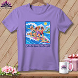 A light purple t-shirt featuring a graphic of three women surfing on a colorful patchwork surfboard.