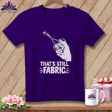 Purple t-shirt with graphic of hand holding scissors cutting fabric, text 