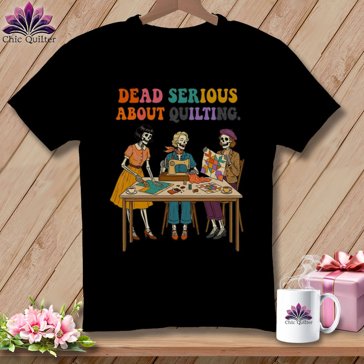 Skeleton quilters sit at a table with a sewing machine and quilt. Text reads "DEAD SERIOUS ABOUT QUILTING."