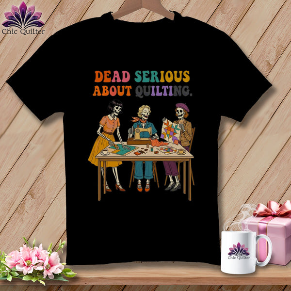 Skeleton quilters sit at a table with a sewing machine and quilt. Text reads "DEAD SERIOUS ABOUT QUILTING."