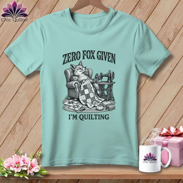 T-shirt with a fox sitting in a chair, holding a quilt, with sewing machine.