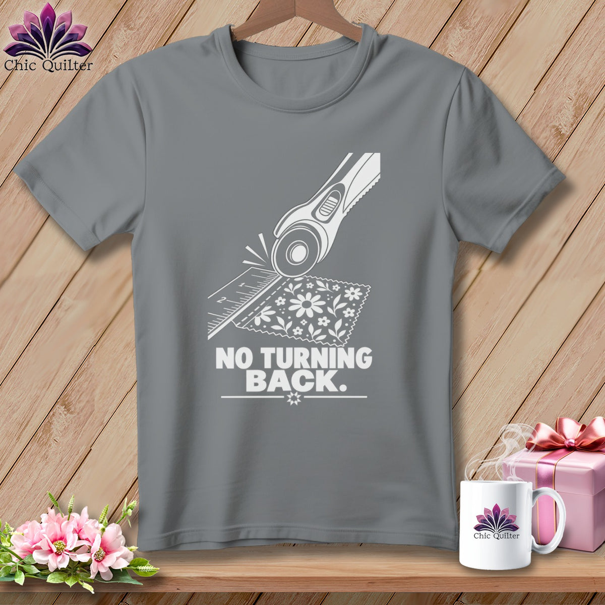 Grey t-shirt with white graphic of rotary cutter, ruler, and fabric, saying "NO TURNING BACK."