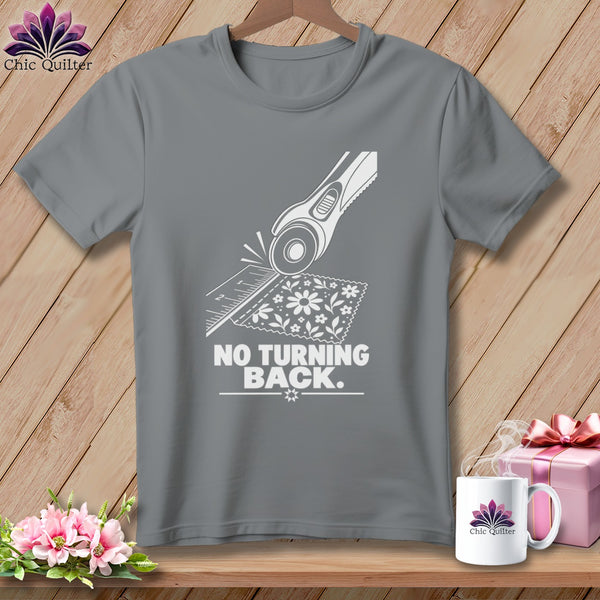 Grey t-shirt with white graphic of rotary cutter, ruler, and fabric, saying "NO TURNING BACK."