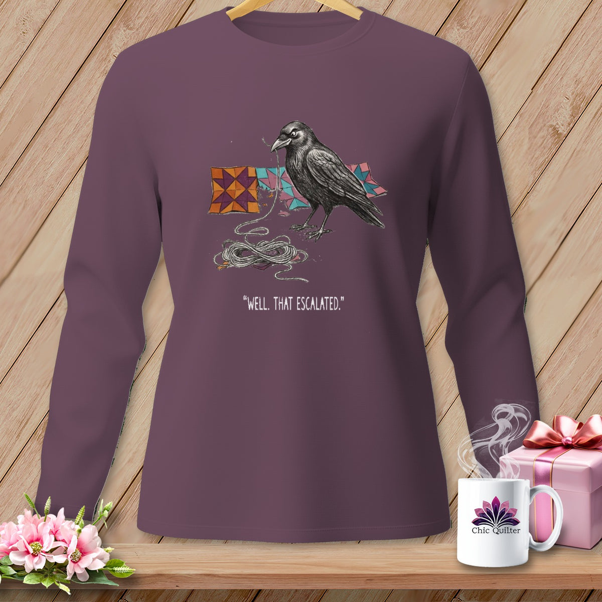 Raven on a purple long-sleeve shirt with string and quilt squares, text "WELL. THAT ESCALATED."